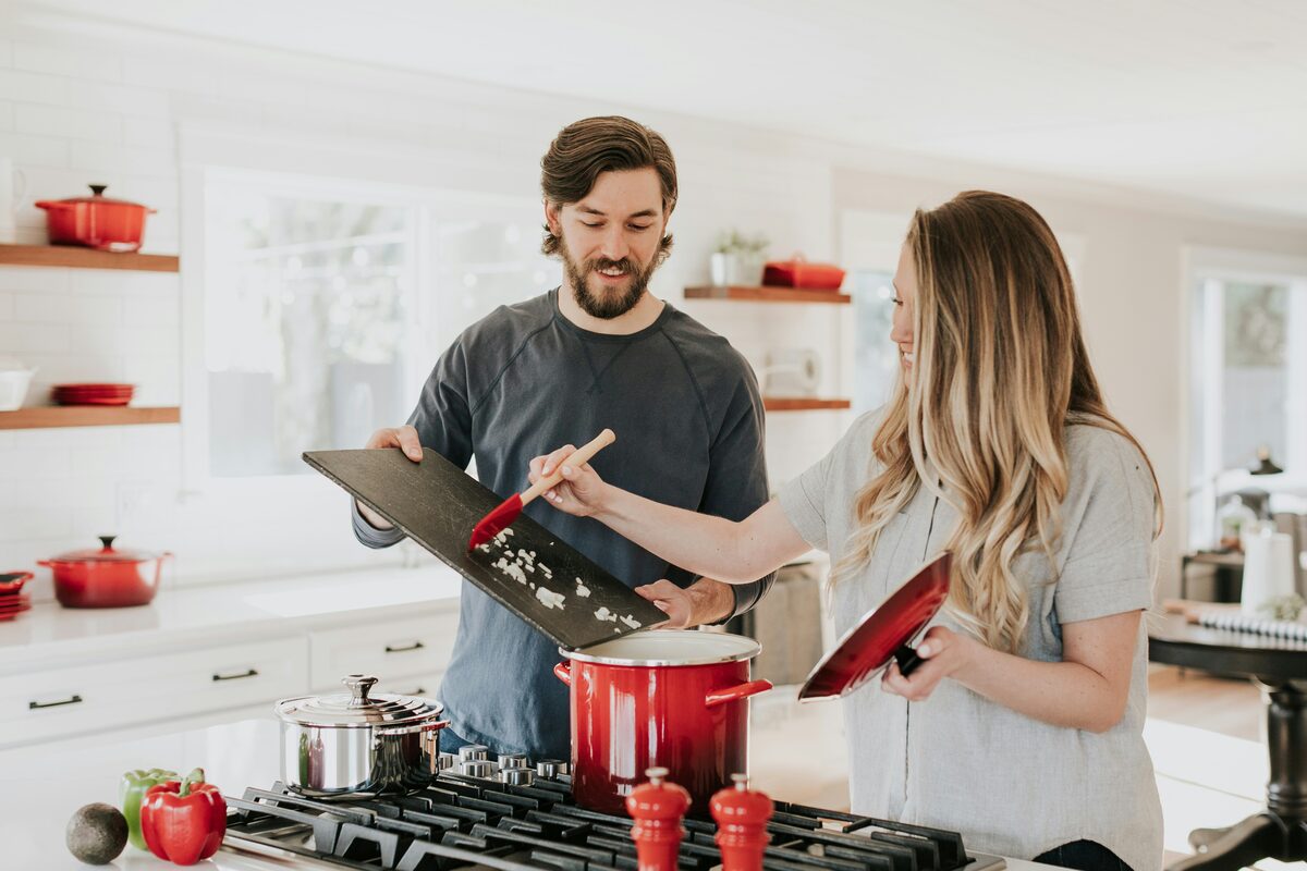 Two founders preparing food in a home kitchen